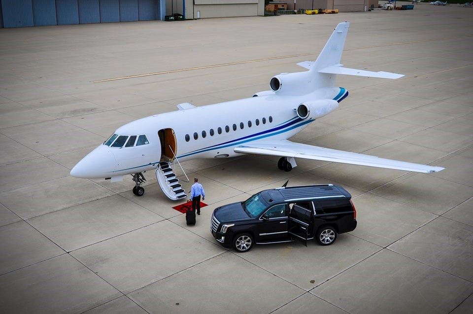 Photo of a man entering a charter jet plane at the airport